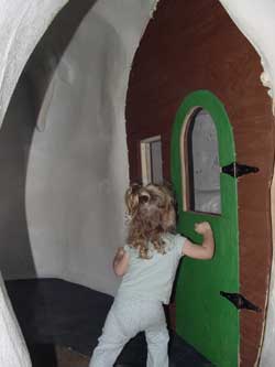 aly knocking on a door in the snow cave