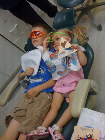 zoe holding toby's hand at the dentist