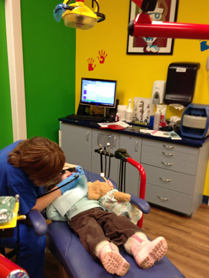 zoe watching dora on the ceiling of the dentist's office